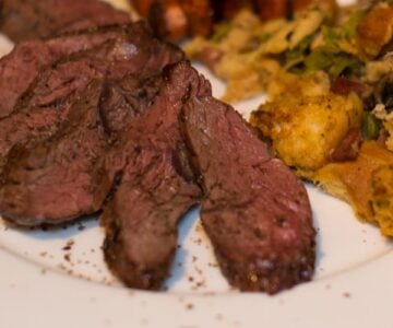 Roasted bison hanger steak with savory bread pudding