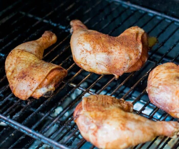 Chicken quarters being smoked
