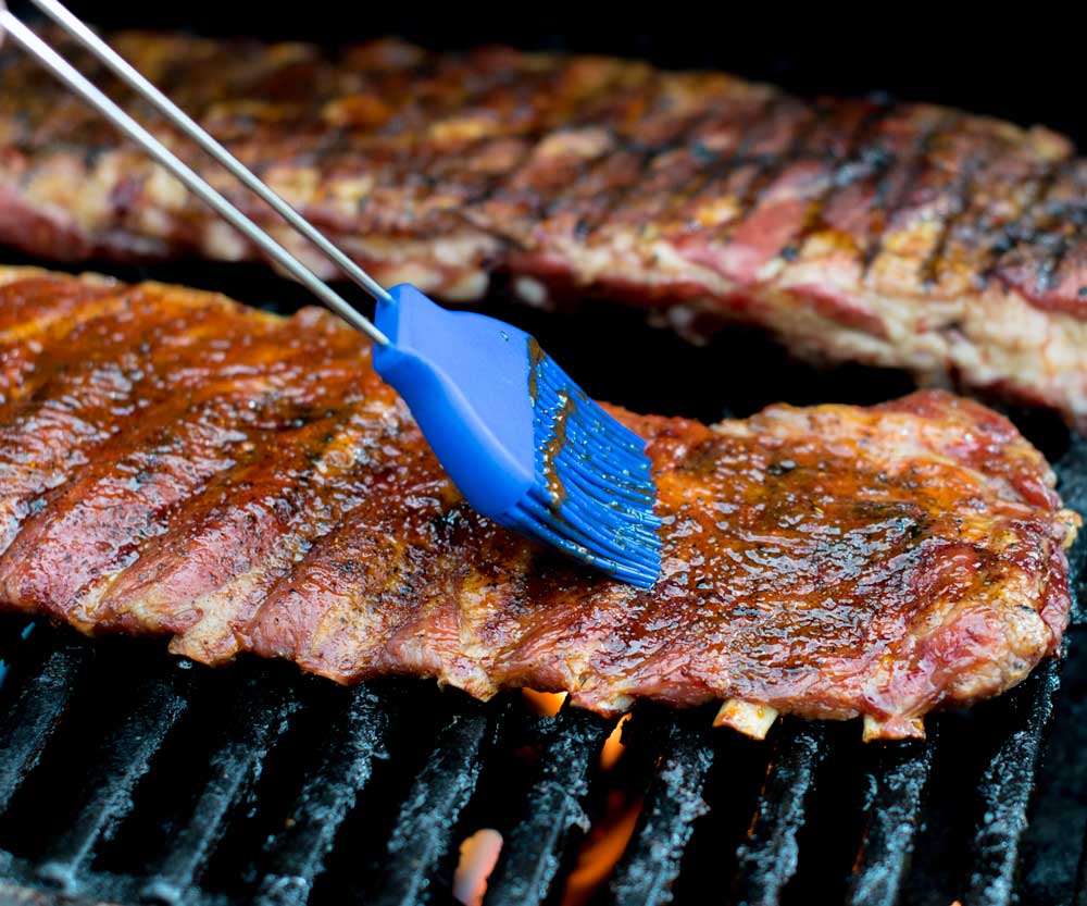 Painting sauce on ribs
